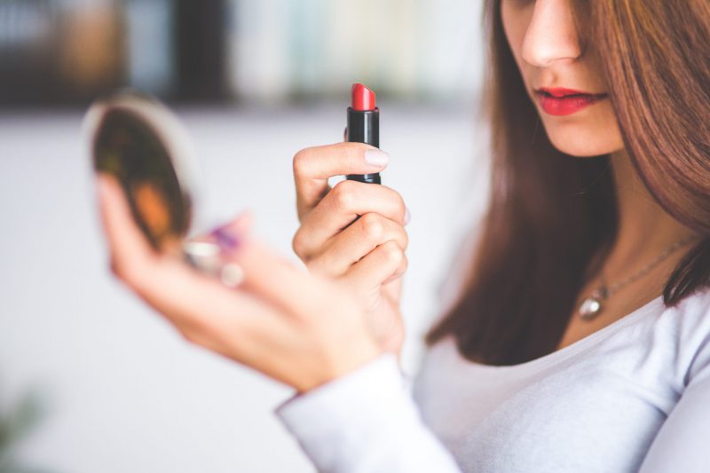 woman applying lipstick